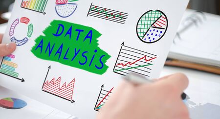 Hands holding a paper showing a data analysis conceptの写真素材