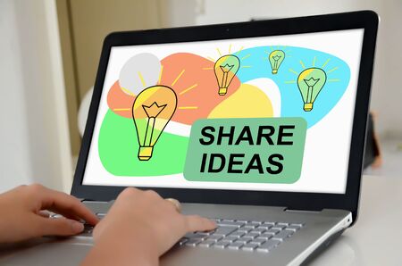 Hands on a laptop with screen showing share ideas conceptの写真素材