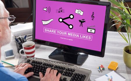 Man using a computer with media likes sharing concept on the screenの写真素材