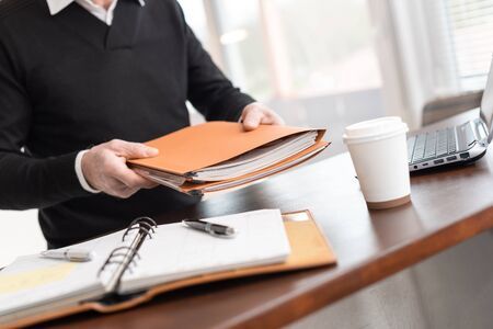 Businessman holding a folder at office