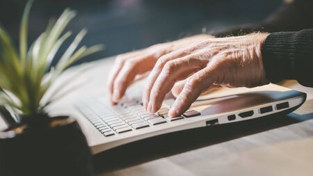 Male hands typing on laptop keyboard