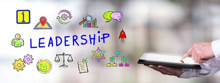 Man using a tablet with leadership conceptの写真素材