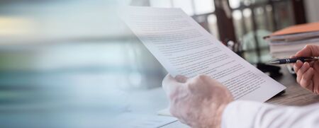 Checking a document in office; panoramic bannerの写真素材