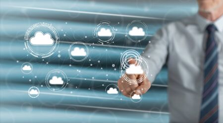 Man touching a cloud networking concept on a touch screen with his fingerの写真素材