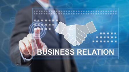 Man touching a business relation concept on a touch screen with his fingersの写真素材