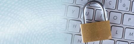 Padlock on computer keyboard; panoramic bannerの写真素材