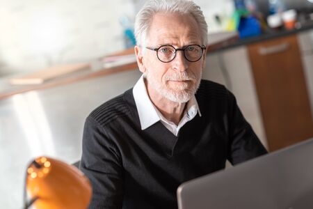 Portrait of senior businessman sitting in office