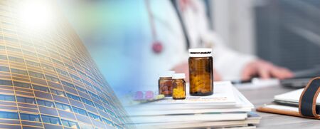Pills and magazines on desk with doctor on background; multiple exposureの写真素材