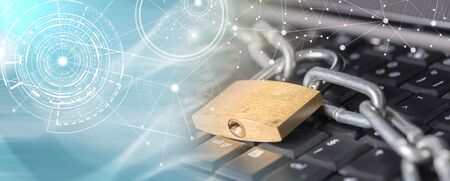 Computer security concept with a padlock and a chain on a keyboard, light effect; multiple exposure