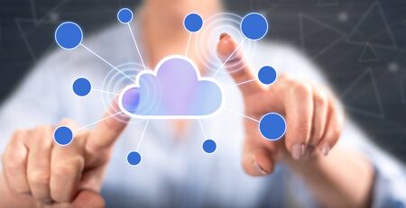 Woman touching a cloud networking on a touch screen with her fingers