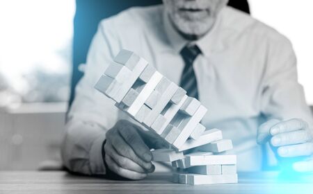 Concept of economy crash with domino tower; light effectの写真素材