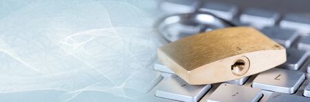 Padlock on computer keyboard, closeup. panoramic banner