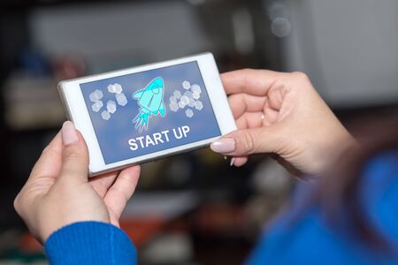 Smartphone screen displaying a start up conceptの写真素材
