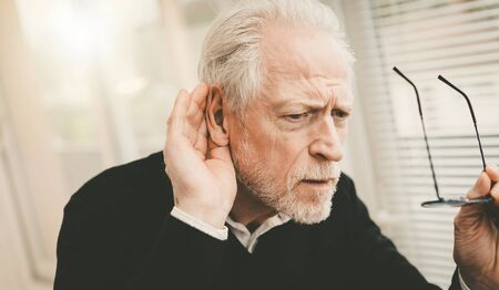 Portrait of senior man having hearing problemsの写真素材