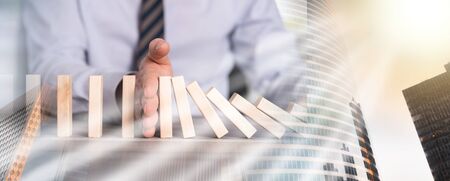 Business control concept by stopping domino effect; multiple exposureの写真素材