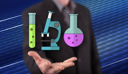 Biotechnology concept above the hand of a man in backgroundの写真素材