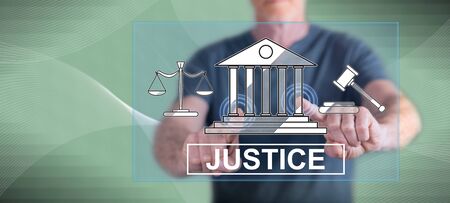 Man touching a justice concept on a touch screen with his fingersの写真素材