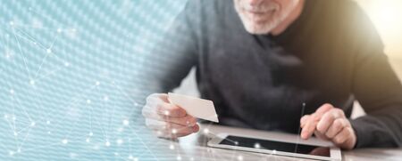 Man using his credit card for online payment; multiple exposure