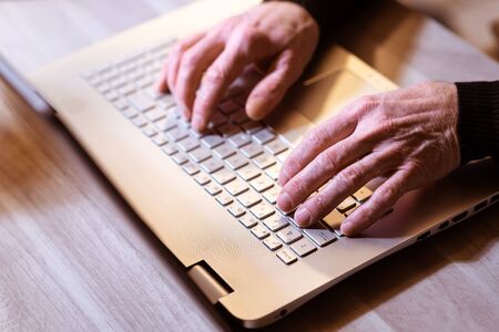 Male hands typing on laptop keyboard