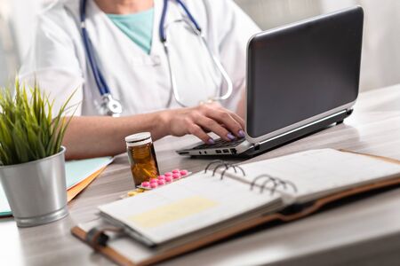 Female doctor using laptop in medical officeの写真素材