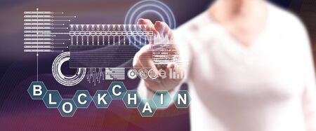 Woman touching a blockchain concept on a touch screen with her fingersの写真素材