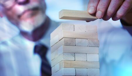 Business development concept by building a tower with domino blocks; light effectの写真素材