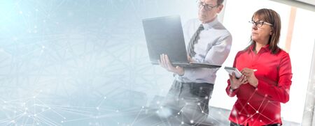 Business people in meeting working on laptop in office; light effect