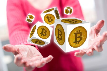 Bitcoin concept above the hands of a woman in backgroundの写真素材