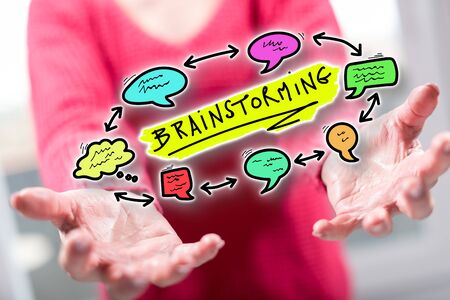 Brainstorming concept above the hands of a woman in backgroundの写真素材