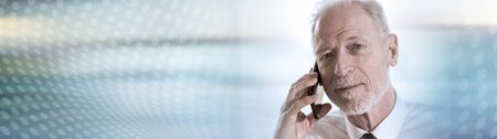 Portrait of senior businessman talking on mobile phone. panoramic bannerの写真素材