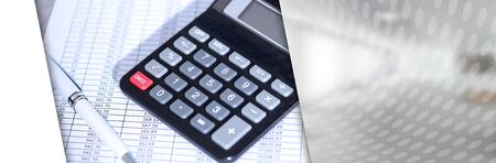 Calculator on financial documents, accounting concept, closeup; panoramic bannerの写真素材