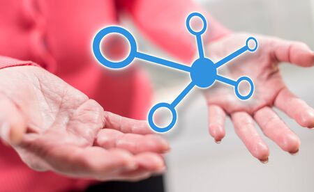 Network concept above the hands of a woman in background