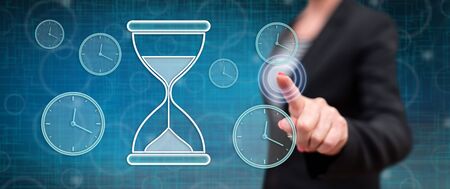 Woman touching a time management concept on a touch screen with her finger