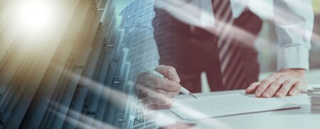 Businessman checking a document in office; multiple exposureの写真素材