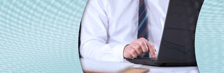 Businessman working on his laptop at office; panoramic banner