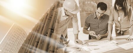 Architects working on plans at office; multiple exposure