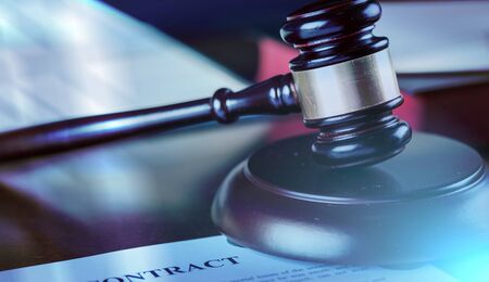 Judge gavel with contract, light effect