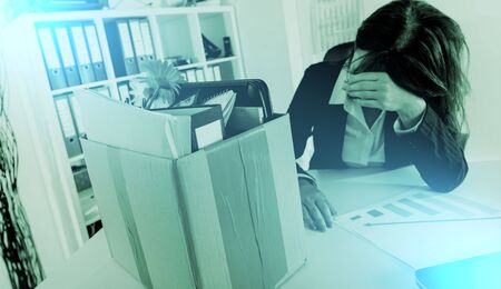 Upset businesswoman fired because of bad results, light effectの写真素材
