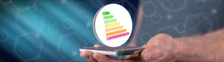 Energy efficiency concept above a smartphone held by a manの写真素材