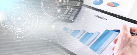 Businessman analyzing financial results with calculator; multiple exposureの写真素材