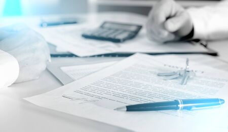 House keys on an estate contract in real estate agency; multiple exposureの写真素材