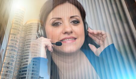 Smiling pretty woman using an headset; multiple exposureの写真素材