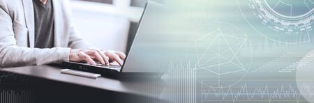 Hands of businessman using laptop at office; panoramic banner