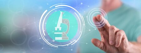 Man touching a scientific research concept on a touch screen with his fingerの写真素材