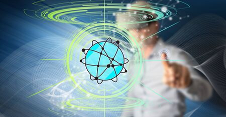 Man with vr headset touching a global network concept on a touch screen with his fingerの写真素材