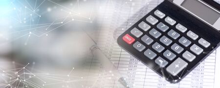 Calculator on financial documents, accounting concept, closeup; multiple exposureの写真素材