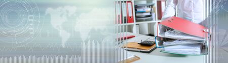 Businesswoman holding binders at office; panoramic banner