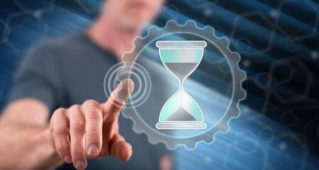 Man touching a time management concept on a touch screen with his finger