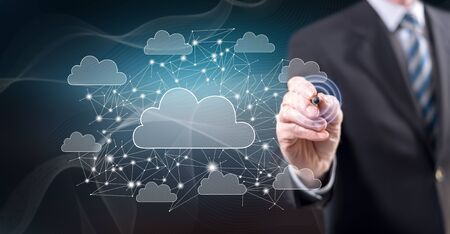 Man touching a cloud networking concept on a touch screen with a stylus penの写真素材