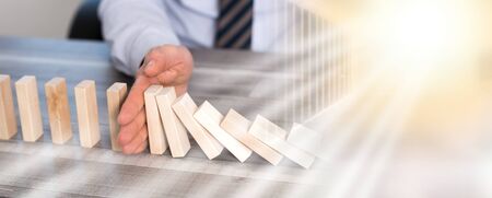 Business control concept by stopping domino effect; multiple exposureの写真素材